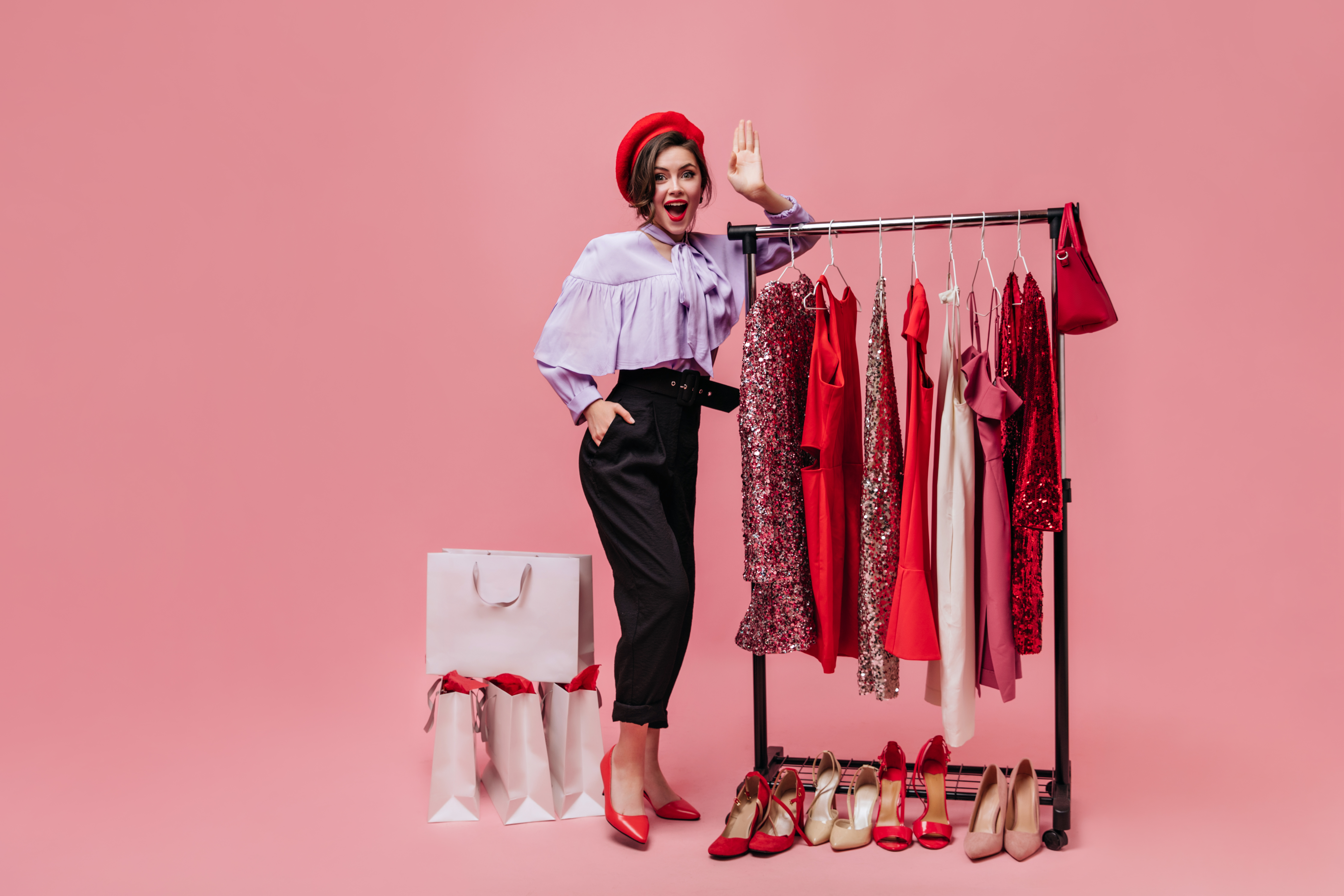 lady-poses-dressing-room-with-bright-clothes-shoes-girl-beret-lilac-blouse-looking-camera-pink-background.jpg