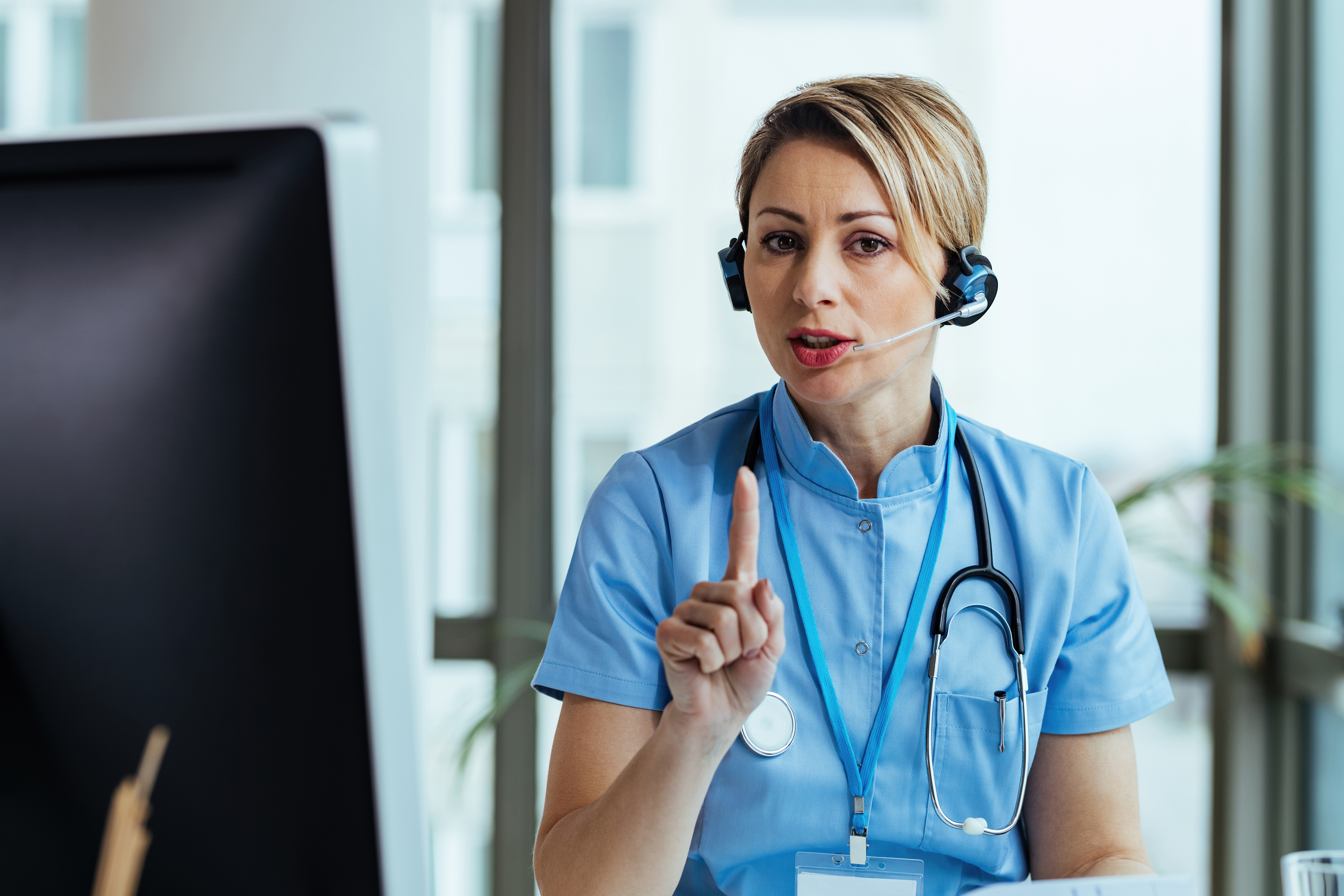 female-healthcare-worker-communicating-with-patient-looking-camera-while-working-medical-call-center.jpg